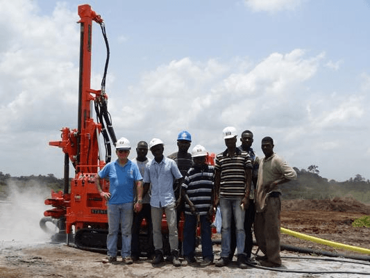 Drilling team with a red rig at a field site