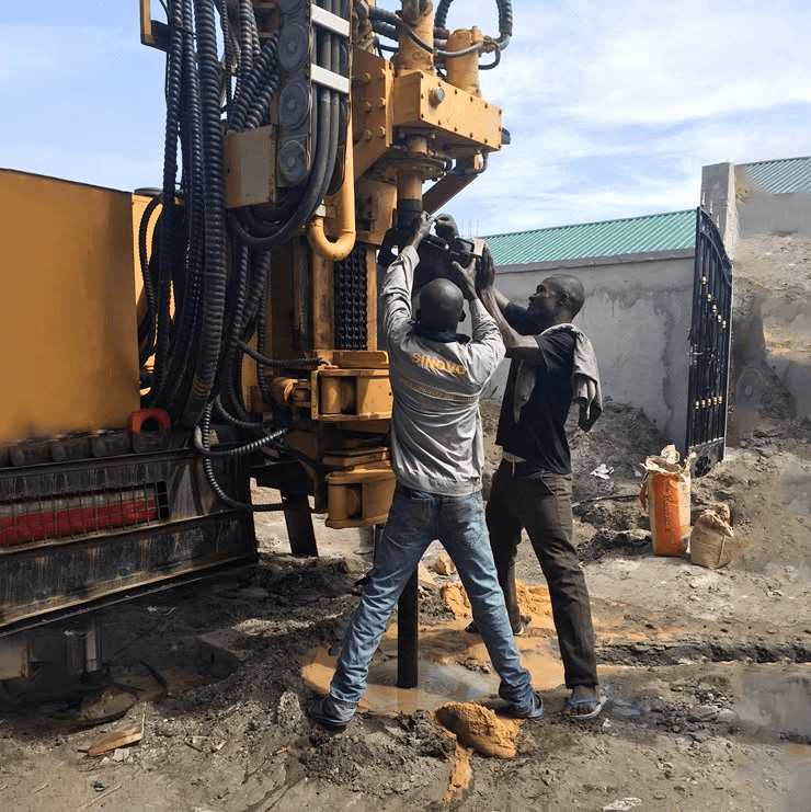 Operators servicing a drilling rig on site